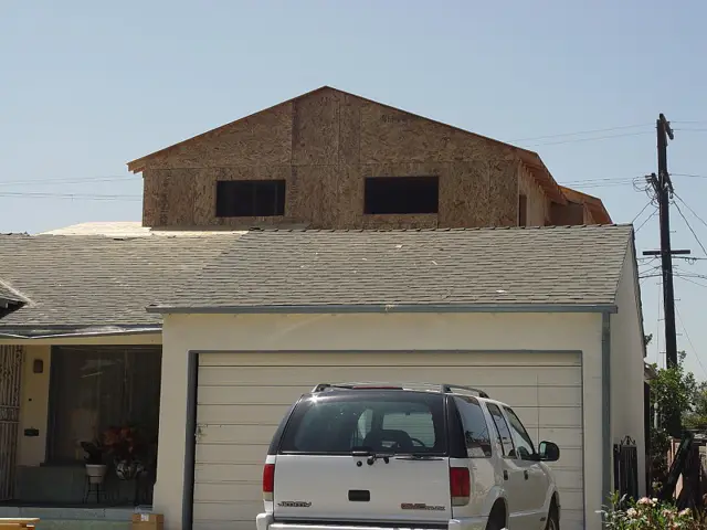 Second story addition framed above an existing garage